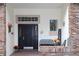 Inviting front porch with black door and seasonal decor at 2360 Park Forest Blvd, Mount Dora, FL 32757