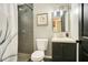 Neutral bathroom with a gray-tiled shower and a modern vanity with shaker cabinets at 622 N Disston Ave, Tavares, FL 32778