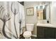 Neutral bathroom with a gray-tiled shower and a modern vanity with shaker cabinets at 622 N Disston Ave, Tavares, FL 32778