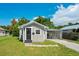 Inviting single-story home featuring a well-kept lawn, carport, and neutral colored facade at 622 N Disston Ave, Tavares, FL 32778