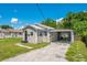 Cozy home featuring a well-kept lawn, a convenient carport, and light grey siding at 622 N Disston Ave, Tavares, FL 32778