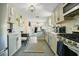 Well-lit kitchen with stainless steel appliances and a view into the cozy living area at 622 N Disston Ave, Tavares, FL 32778