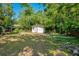 A small shed is on the property, ideal for additional storage and outdoor projects, set in a backyard setting at 622 N Disston Ave, Tavares, FL 32778