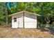 Storage shed with a single door and a window located on a mature lot providing additional space for storage at 622 N Disston Ave, Tavares, FL 32778