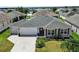 Aerial view of home in a neighborhood with lush landscaping and well-maintained lawns at 736 Jones Ln, The Villages, FL 32163