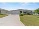 Single-story house with a two-car garage and well-manicured lawn at 736 Jones Ln, The Villages, FL 32163