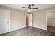 Spacious bedroom with wood-look floors and access to bathroom at 11712 Layton St, Leesburg, FL 34788