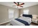 Bright bedroom with a comfortable bed, ceiling fan, and window coverings at 11712 Layton St, Leesburg, FL 34788