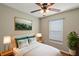 Bedroom with ceiling fan, wood floors and large mirror at 11712 Layton St, Leesburg, FL 34788