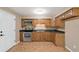 Wood cabinets, stainless steel appliances and tile floor in kitchen at 11712 Layton St, Leesburg, FL 34788