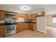 Kitchen features wood cabinets and stainless steel appliances at 11712 Layton St, Leesburg, FL 34788