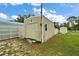 Large storage shed with a window and grassy surroundings at 11712 Layton St, Leesburg, FL 34788