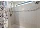 Bathroom featuring tiled walls, a shower head and window at 1605 W Schwartz Blvd, The Villages, FL 32159