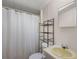 Functional bathroom features a shower-tub combo, neutral colors, and sink with shelf at 1605 W Schwartz Blvd, The Villages, FL 32159