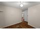 Bedroom shows wood flooring, ceiling fan, and view of hallway at 1605 W Schwartz Blvd, The Villages, FL 32159