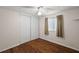 Cozy bedroom featuring wood flooring, a ceiling fan, and a closet with sliding doors at 1605 W Schwartz Blvd, The Villages, FL 32159