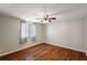 Bright bedroom featuring hardwood floors, a ceiling fan and a window letting in natural light at 1605 W Schwartz Blvd, The Villages, FL 32159