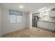 A kitchen with stainless steel refrigerator, stove, ample counter space and bright lighting at 1605 W Schwartz Blvd, The Villages, FL 32159