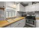 Kitchen area showcasing ample counter space with wood-look countertops and bright lighting at 1605 W Schwartz Blvd, The Villages, FL 32159