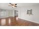 Living room with hardwood flooring, ceiling fan and a serving hatch view at 1605 W Schwartz Blvd, The Villages, FL 32159