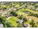 Aerial view of neighborhood on golf course showing lush landscape and ponds at 557 Dowling Cir, Lady Lake, FL 32159