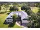 Aerial view of home showing circular driveway and lush, green landscaping at 557 Dowling Cir, Lady Lake, FL 32159