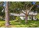 Landscaped backyard with mature trees and a large grassy area at 557 Dowling Cir, Lady Lake, FL 32159