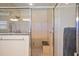 Shower with glass door and tile surround, complete with a granite bench at 557 Dowling Cir, Lady Lake, FL 32159