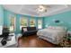 Bright bedroom with teal walls, wood floors, and a comfortable bed at 557 Dowling Cir, Lady Lake, FL 32159