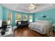 Bright bedroom with wood floors, ample natural light, and a ceiling fan at 557 Dowling Cir, Lady Lake, FL 32159