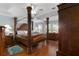 Primary bedroom with a large four-poster bed and hardwood floors at 557 Dowling Cir, Lady Lake, FL 32159