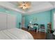 Main bedroom with teal walls, wood floors, and a sitting area at 557 Dowling Cir, Lady Lake, FL 32159