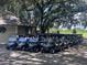 Row of golf carts parked beside a building in a golf community, ready for a day on the course at 557 Dowling Cir, Lady Lake, FL 32159