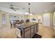 Kitchen island with granite countertop, pendant lights, and tile floors at 557 Dowling Cir, Lady Lake, FL 32159