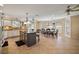 Open kitchen and dining area with granite island, tile flooring, and natural light at 557 Dowling Cir, Lady Lake, FL 32159