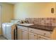 Laundry room with side-by-side washer and dryer and granite countertop at 557 Dowling Cir, Lady Lake, FL 32159