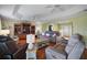 Spacious living room with hardwood floors, tray ceiling, and ample seating at 557 Dowling Cir, Lady Lake, FL 32159