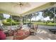 Relaxing screened porch overlooking a lush green golf course at 557 Dowling Cir, Lady Lake, FL 32159