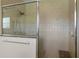 Large walk-in shower with tiled walls and built-in seat at 557 Dowling Cir, Lady Lake, FL 32159