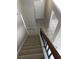 Indoor view of a carpeted staircase with a wooden handrail at 849 Millrace Pt, Longwood, FL 32750