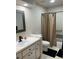 Clean bathroom featuring a shower-tub combo and a modern vanity with great lighting at 21945 King Henry Ave, Leesburg, FL 34748