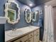 Double vanity bathroom with decorative mirrors and shower at 21945 King Henry Ave, Leesburg, FL 34748