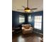 Cozy bedroom with dark blue walls, hardwood flooring, and a ceiling fan at 21945 King Henry Ave, Leesburg, FL 34748