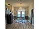 Elegant dining room with hardwood floors, chandelier, and natural light from the large windows at 21945 King Henry Ave, Leesburg, FL 34748