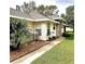 Well-maintained exterior with side yard and walkway at 21945 King Henry Ave, Leesburg, FL 34748