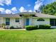 Charming single-story home with a well-manicured front yard, bright blue door, and inviting curb appeal at 21945 King Henry Ave, Leesburg, FL 34748