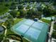 Aerial view of tennis courts, showcasing a well-maintained recreational amenity within the community at 21945 King Henry Ave, Leesburg, FL 34748