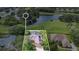 Expansive aerial view showcasing the home's screened-in pool, large lot, and serene surroundings with a pond nearby at 5008 Greenbriar Trl, Mount Dora, FL 32757