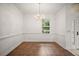 Classic dining room showcasing white walls, tile floors, wainscotting and a chandelier at 5008 Greenbriar Trl, Mount Dora, FL 32757