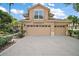 Two-story home featuring a three-car garage, and well-maintained landscaping at 5008 Greenbriar Trl, Mount Dora, FL 32757